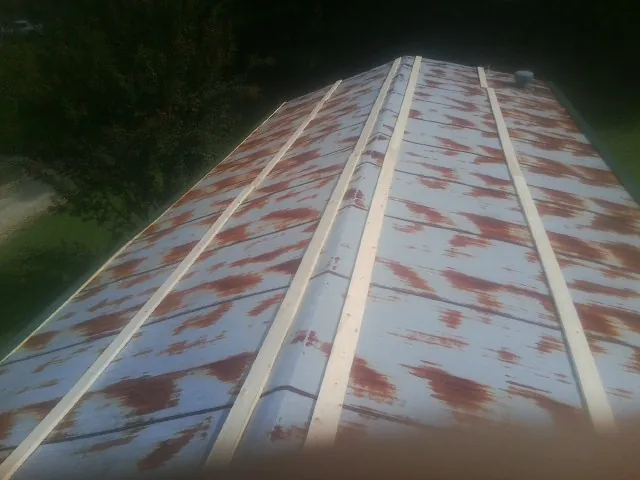 Rusted metal roof panels with new wood purlins before replacement — Storm Damage Roof Repair in Moss Beach by Roofing Brothers